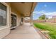 Inviting covered back patio offers a perfect space for outdoor relaxation and entertaining with a view of the backyard at 11010 W Palm Ln, Avondale, AZ 85392