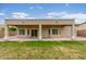 A well-maintained backyard features a covered patio, lush lawn, and ample space for outdoor activities at 11010 W Palm Ln, Avondale, AZ 85392