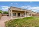 Expansive backyard featuring a covered patio, lush lawn, and privacy fence, offering a private outdoor retreat at 11010 W Palm Ln, Avondale, AZ 85392