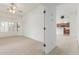 Spacious bedroom featuring carpet, shutters and access to other rooms at 11010 W Palm Ln, Avondale, AZ 85392