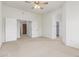 Spacious bedroom with a ceiling fan, white walls, carpeted floors, and plenty of closet space at 11010 W Palm Ln, Avondale, AZ 85392