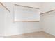 Walk-in closet providing ample storage space with custom shelving and wooden support rods at 11010 W Palm Ln, Avondale, AZ 85392