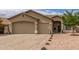 Single-story home features neutral stucco, low maintenance desert landscaping, and a convenient three-car garage at 11010 W Palm Ln, Avondale, AZ 85392