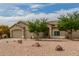 Single-story home features neutral stucco, low maintenance desert landscaping, and a convenient three-car garage at 11010 W Palm Ln, Avondale, AZ 85392