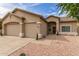 Single-story home features neutral stucco, low maintenance desert landscaping, and a convenient three-car garage at 11010 W Palm Ln, Avondale, AZ 85392