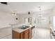 Open kitchen with wood cabinets and view to carpeted living room at 11010 W Palm Ln, Avondale, AZ 85392
