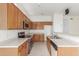 A view of the kitchen with wood cabinets, and stainless steel appliances at 11010 W Palm Ln, Avondale, AZ 85392
