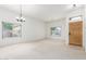 Bright, airy living room features neutral walls, plush carpet, and large windows for abundant natural light at 11010 W Palm Ln, Avondale, AZ 85392