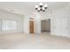 Bright, airy living room features neutral walls, plush carpet, and a front door at 11010 W Palm Ln, Avondale, AZ 85392