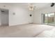 View of living room with carpet, speakers, and access to patio and other rooms at 11010 W Palm Ln, Avondale, AZ 85392