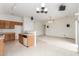 Open-concept area featuring carpeted living room and tile-floored kitchen at 11010 W Palm Ln, Avondale, AZ 85392