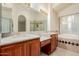 Bathroom features dual sinks, marble countertop, stylish faucets, a glass enclosed shower, and large soaking tub at 1139 E Stephens Dr, Tempe, AZ 85283