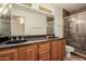 Bathroom featuring dual sinks and a glass-enclosed shower at 1139 E Stephens Dr, Tempe, AZ 85283