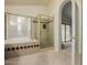 Bathroom features tub and separate shower, complemented by a large window, creating a bright and airy space at 1139 E Stephens Dr, Tempe, AZ 85283