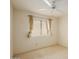 Bright bedroom with neutral carpet, ceiling fan, and large window with stylish curtains at 1139 E Stephens Dr, Tempe, AZ 85283