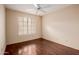 Bedroom features wood floors and a ceiling fan, with a large window at 1139 E Stephens Dr, Tempe, AZ 85283