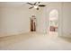 Spacious bedroom features neutral carpet, ceiling fan, and doorway to the ensuite bathroom at 1139 E Stephens Dr, Tempe, AZ 85283
