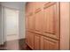Hallway featuring floor-to-ceiling wooden storage cabinets at 1139 E Stephens Dr, Tempe, AZ 85283