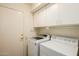 Laundry room with cabinets and a modern washer and dryer at 1139 E Stephens Dr, Tempe, AZ 85283