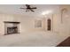 The spacious living room features a tile fireplace, bright neutral paint, and a ceiling fan at 1139 E Stephens Dr, Tempe, AZ 85283