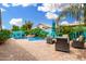 Lush backyard features a private pool with a waterfall feature and comfortable patio seating under an umbrella at 1144 W Tremaine Ave, Gilbert, AZ 85233
