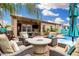 Beautiful outdoor living space features cozy seating around a fire pit, with the pool nearby at 1144 W Tremaine Ave, Gilbert, AZ 85233