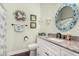 Nautical themed bathroom featuring granite counters, decorative mirror, and coordinated accessories at 1144 W Tremaine Ave, Gilbert, AZ 85233