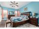 This relaxing bedroom features a ceiling fan, an en suite bathroom, and plenty of natural light at 1144 W Tremaine Ave, Gilbert, AZ 85233