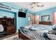 This bedroom features blue walls, a barn door to the en suite bathroom, and a ceiling fan at 1144 W Tremaine Ave, Gilbert, AZ 85233