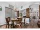Cozy dining area features a round table with seating for six, modern window shades, and decorative chandelier at 1144 W Tremaine Ave, Gilbert, AZ 85233