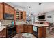 Well-lit kitchen features sleek granite countertops, mosaic tile backsplash and modern black appliances at 1144 W Tremaine Ave, Gilbert, AZ 85233