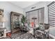 Cozy sitting area with patterned armchairs and a display cabinet at 1144 W Tremaine Ave, Gilbert, AZ 85233