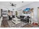 Spacious living room features an open floorplan, modern decor, and wood-style flooring at 1144 W Tremaine Ave, Gilbert, AZ 85233