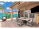 Inviting covered patio with wicker furniture, perfect for outdoor dining and relaxation at 1144 W Tremaine Ave, Gilbert, AZ 85233