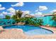 Beautiful pool with waterfall feature surrounded by lush landscaping and a bright blue privacy wall at 1144 W Tremaine Ave, Gilbert, AZ 85233