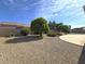 Large backyard featuring desert landscaping, mature trees, and a covered patio, ideal for entertaining at 1210 E Westchester Dr, Chandler, AZ 85249