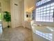 Bright bathroom with a soaking tub and glass block window for privacy at 1210 E Westchester Dr, Chandler, AZ 85249