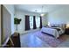 Bright bedroom featuring tile floors, natural light, and a comfortable queen-sized bed at 1210 E Westchester Dr, Chandler, AZ 85249