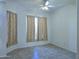 Neutral bedroom with tile flooring, ceiling fan, and window with light-colored curtains at 1210 E Westchester Dr, Chandler, AZ 85249