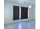 Bedroom features tile flooring, ceiling fan, and window with dark-colored curtains at 1210 E Westchester Dr, Chandler, AZ 85249