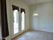 Dining area features glass french doors, pendant lighting, and neutral tile flooring at 1210 E Westchester Dr, Chandler, AZ 85249