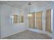 Well-lit dining room with hanging light fixture, mirrored accent, and tan-colored curtains at 1210 E Westchester Dr, Chandler, AZ 85249