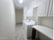 The laundry room has cabinets, a folding table, and washer/dryer hookups at 1210 E Westchester Dr, Chandler, AZ 85249