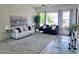 Spacious living room with ample seating, neutral tones, modern decor, with bright windows and glass coffee table at 1210 E Westchester Dr, Chandler, AZ 85249
