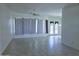 Bright living room features neutral tile flooring, ceiling fan, and ample natural light from large windows at 1210 E Westchester Dr, Chandler, AZ 85249