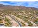 An aerial view of the community surrounded by the stunning desert landscape and picturesque mountains at 12225 E Cortez Dr, Scottsdale, AZ 85259
