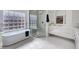 Bright bathroom featuring a soaking tub, frameless shower, and double sink vanity at 12225 E Cortez Dr, Scottsdale, AZ 85259