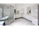 Large bathroom featuring dual vanities, sleek white cabinets, and a glass enclosed shower at 12225 E Cortez Dr, Scottsdale, AZ 85259