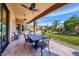 Enjoy outdoor dining on this covered patio with ceiling fans, overlooking the beautifully landscaped backyard at 12225 E Cortez Dr, Scottsdale, AZ 85259