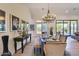 Bright dining area with a stylish chandelier and views of the outdoors at 12225 E Cortez Dr, Scottsdale, AZ 85259